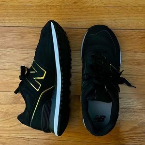 Womens New Balance black sneakers with chrome accents